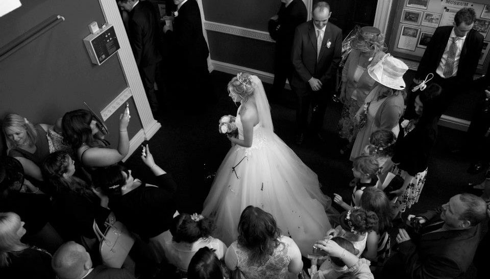 A Newlywed Bride having her photo taken in the Foyer at Bedale Hall.