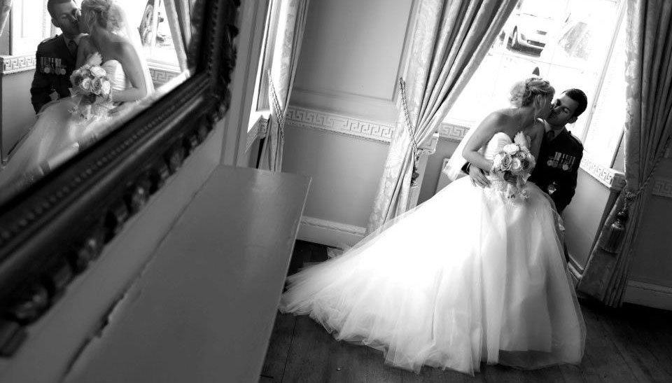 A Newlywed Couple sharing a moment in the Bedale Room at Bedale Hall.